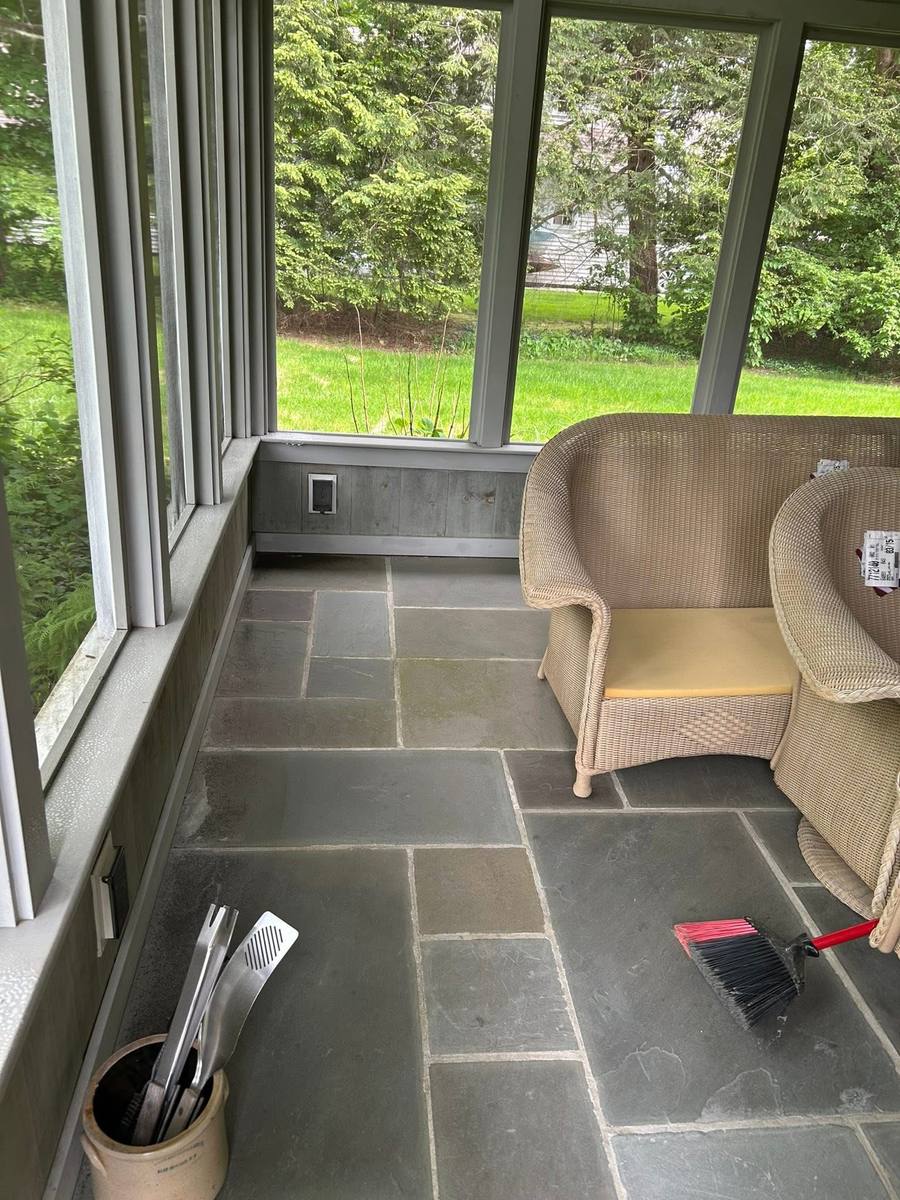 Screened porch with a stone floor